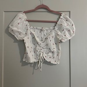 Cinch front crop top. White with pink floral detail